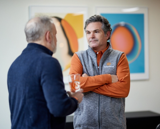 MonogramGroup Hero Photo of (Left) Scott Markman, Founder/President, and (Right) Chip Balch, Partner/Creative Director, conversing at the office.